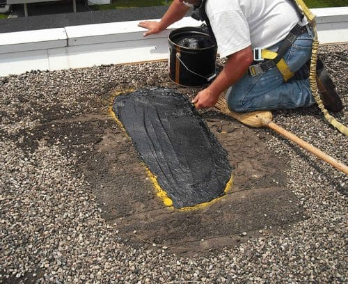 expert roofer repairing a commercial roof in Lake County, IL